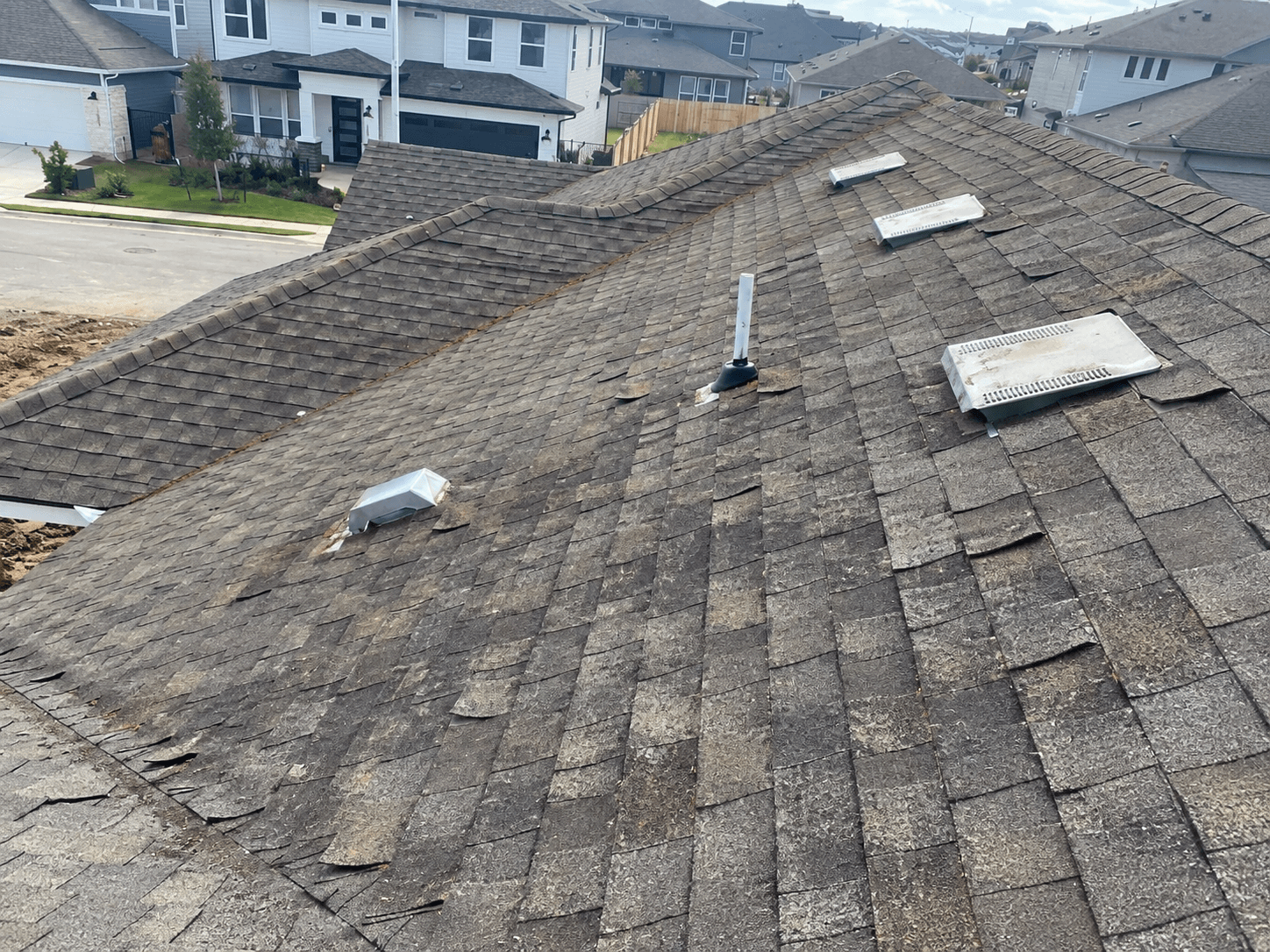Deteriorated residential roof before roofing work